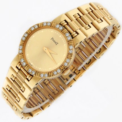 Piaget Dancer Round Ladies 18K Yellow Gold Bracelet Wristwatch with Diamond Bezel and Champagne Dial. 23mm Diameter. Wears up to 6.25 inches. Model Reference 80564 K81. Retail Price $15,350.
