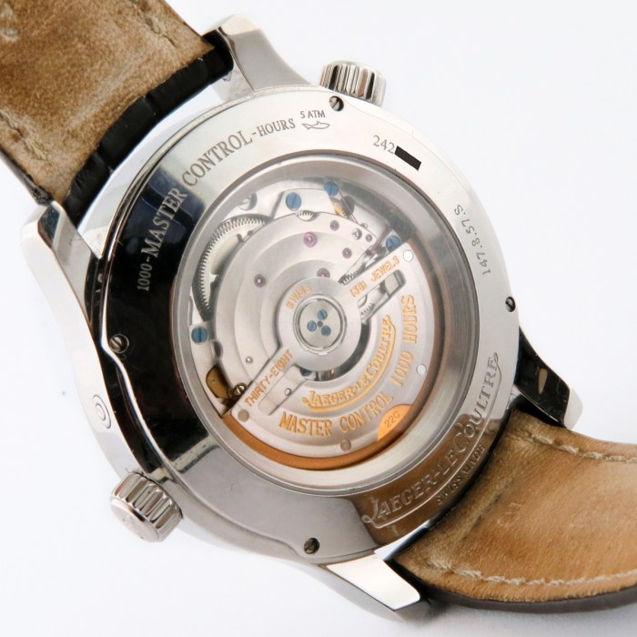 Back view of a Jaeger-LeCoultre Master Control watch with a transparent case back showing the mechanical movement and rotor, attached to a brown leather strap