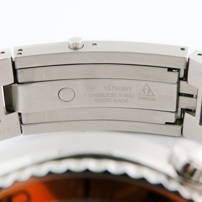 Close-up of a stainless steel Omega watch clasp with engravings: 1579/951, SWISS MADE, Omega logo.