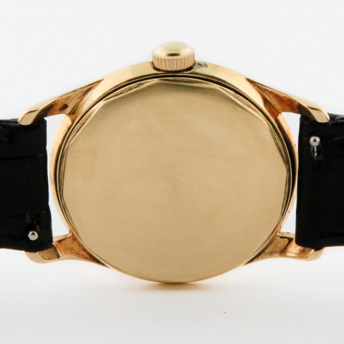 Rare Tiffany & Co. Vintage 14K Solid Yellow Gold Screwback Case Black Gilt Dial Mens Wristwatch made by Agassiz. Circa 1930s. 33mm