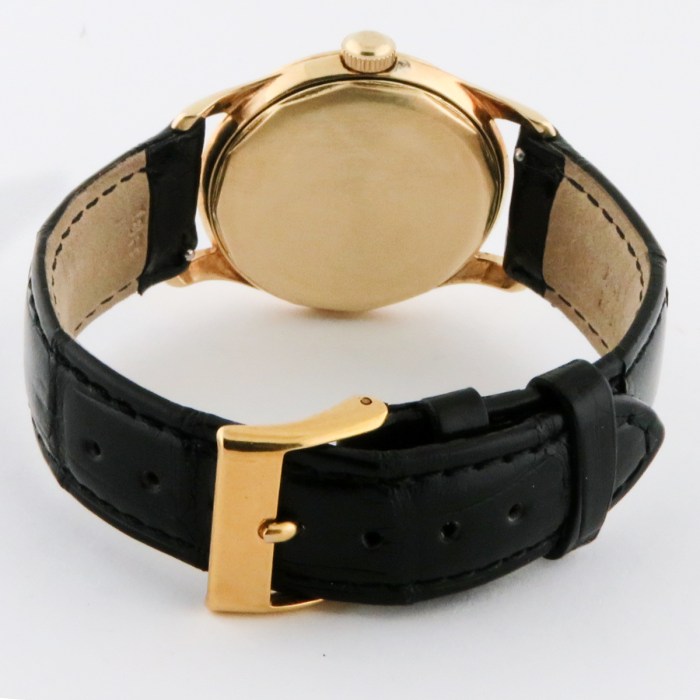 Rare Tiffany & Co. Vintage 14K Solid Yellow Gold Screwback Case Black Gilt Dial Mens Wristwatch made by Agassiz. Circa 1930s. 33mm