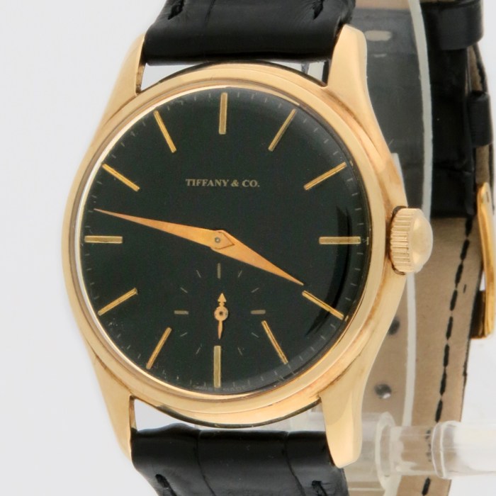 Rare Tiffany & Co. Vintage 14K Solid Yellow Gold Screwback Case Black Gilt Dial Mens Wristwatch made by Agassiz. Circa 1930s. 33mm