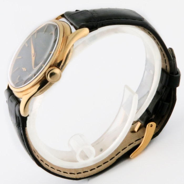 Rare Tiffany & Co. Vintage 14K Solid Yellow Gold Screwback Case Black Gilt Dial Mens Wristwatch made by Agassiz. Circa 1930s. 33mm