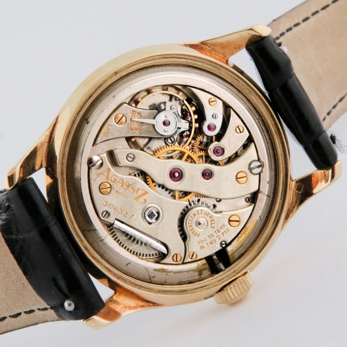 Rare Tiffany & Co. Vintage 14K Solid Yellow Gold Screwback Case Black Gilt Dial Mens Wristwatch made by Agassiz. Circa 1930s. 33mm