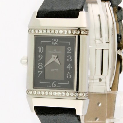 Square-faced silver wristwatch with a diamond-studded bezel and black strap, shown in close-up.