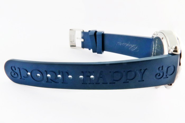 Blue silicone sports watch strap with embossed lettering, laid flat on a white background.