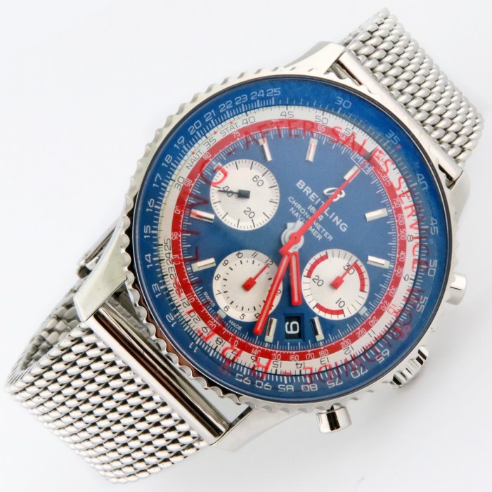 Breitling Navitimer chronograph wristwatch with a blue dial, red hands, white subdials, and a stainless steel mesh bracelet
