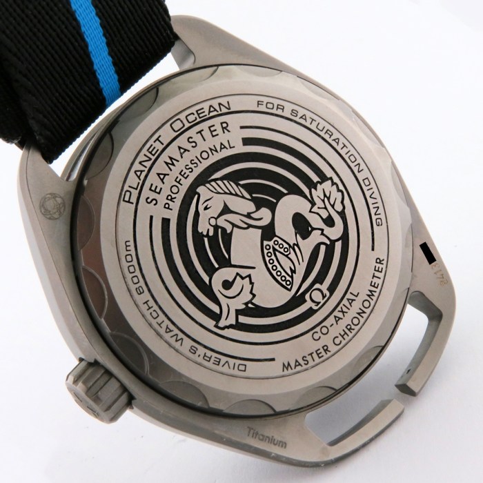Close-up of an Omega Seamaster Planet Ocean case back with the seahorse logo and engraved text