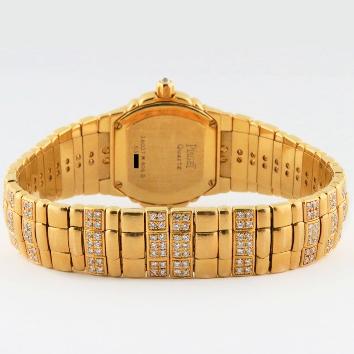 Top luxury watch Piaget Tanagra Ladies 18K Yellow Gold Watch with full PAVE factory diamond & ruby dial. Ref.16037 M 406 D. 25mm MSRP $68,780